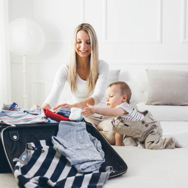 Mom packing for a vacation with her infant