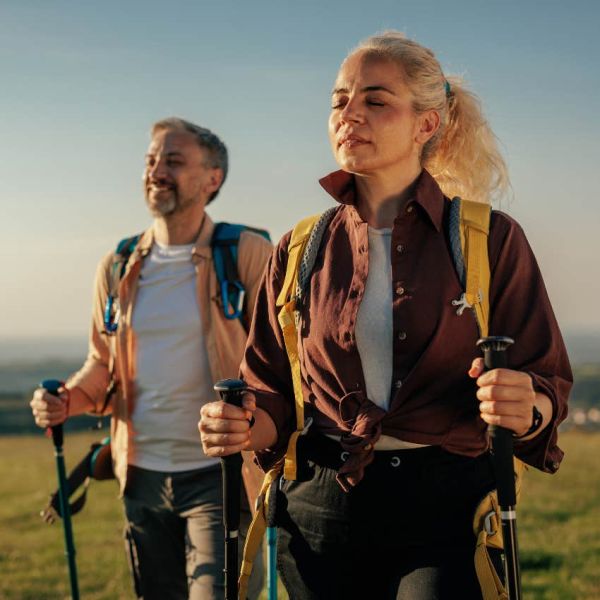 Couple enjoying their "micro-retirement" by hiking together outside. 