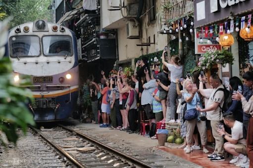 Tourists taking photos of a train on Train Street in March of 2023. Photo by VnExpress/Ngoc Thanh