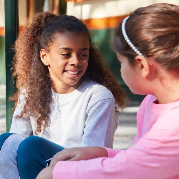 Children talking together on the playground. 