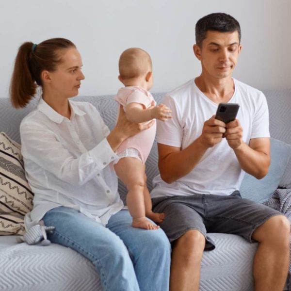 dad on phone ignoring baby 