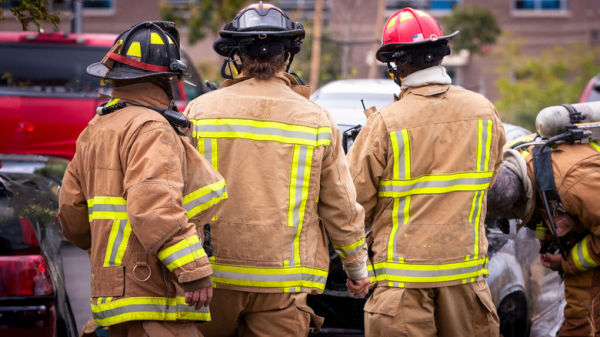 Three firefighters standing around