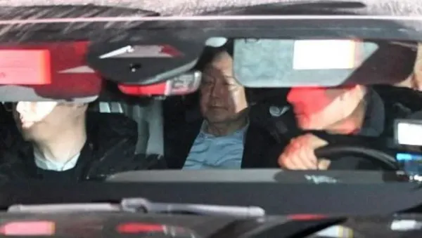 A vehicle carrying impeached South Korea President Yoon Suk Yeol (C) leaves the complex building housing the Corruption Investigation Office for High-ranking Officials (CIO) in Gwacheon on January 15, 2025. Impeached South Korean leader Yoon Suk Yeol was arrested on January 15 over his failed martial law bid, ending a weeks-long standoff with authorities and becoming the first sitting president to be detained in the nations history. (Photo by JUNG YEON-JE / AFP)