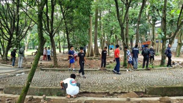 Sejumlah warga mencari koin (berburu harta karun) di kawasan Taman Tegallega, Jln. Moch. Toha, Kota Bandung, Jumat (10/1/2025).