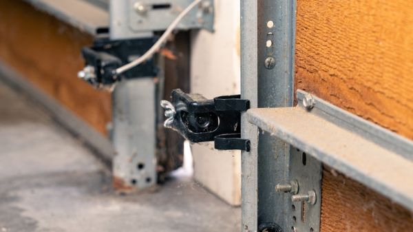 Two garage doors equipped with safety sensors.