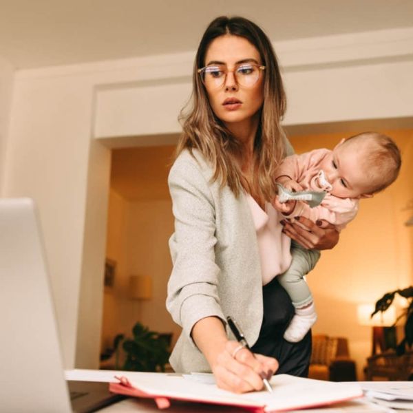 woman working on computer with baby