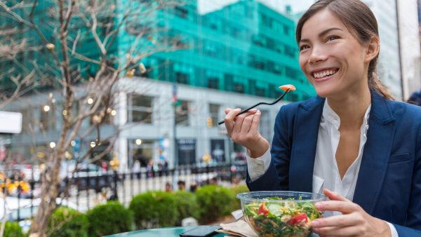 Woman who didn't bring a pre-packed lunch to work and is experiencing lifestyle creep