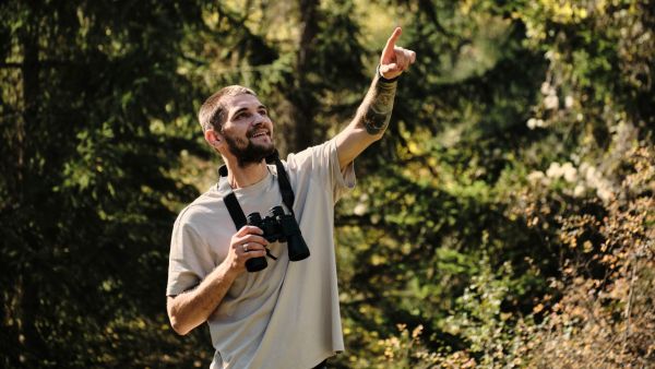 Gen Z man doing boomer hobby birdwatching