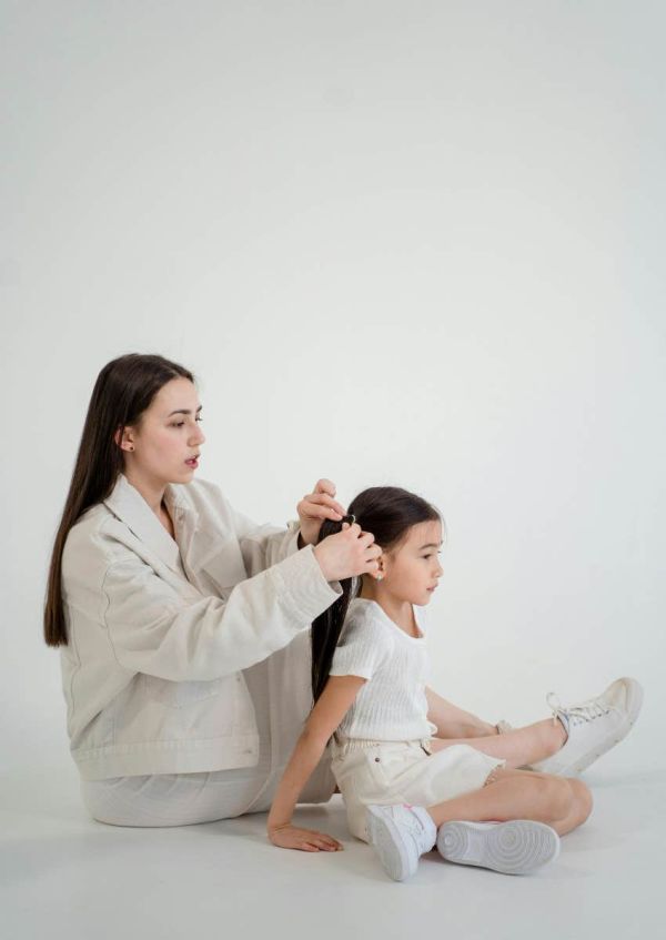 parent doing her child's hair