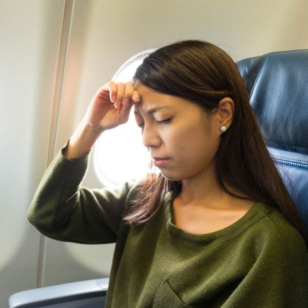 woman uncomfortable on plane 