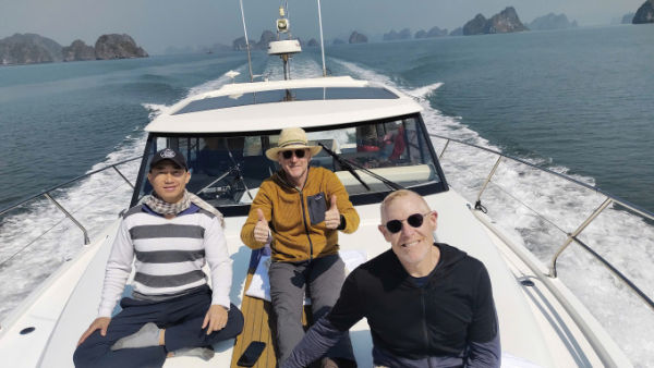 Jeff Grinspoon (in black shirt) and Jon Thomas Foley (in yellow shirt) take a boat trip on Ha Long Bay on February 11, 2024 Photo courtesy of AAV