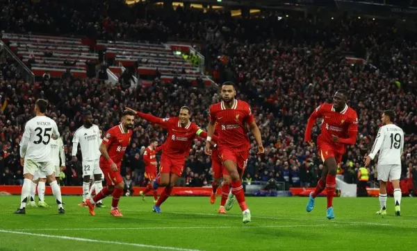 Soccer Football - Champions League - Liverpool v Real Madrid - Anfield, Liverpool, Britain - November 27, 2024 Liverpool's Cody Gakpo celebrates scoring their second goal with Mohamed Salah, Virgil van Dijk and Ibrahima Konate REUTERS/Molly Darlington