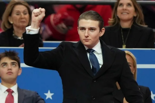 Barron raises his fist after his father invites him to stand and receive applause from the audience. Photo from AP