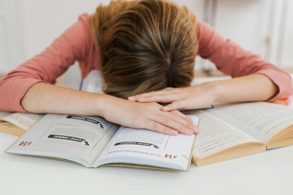 Photo by Photo By: Kaboompics.com: https://www.pexels.com/photo/a-girl-with-books-5877583/