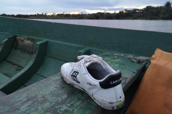 A white shoe in a green boat