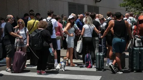 A man holds passports, as people of foreign nationalities gather to leave Israel on buses via Egypt, following a missile attack from Iran, in Tel Aviv, Israel, June 17, 2025. REUTERS/Ronen Zvulun