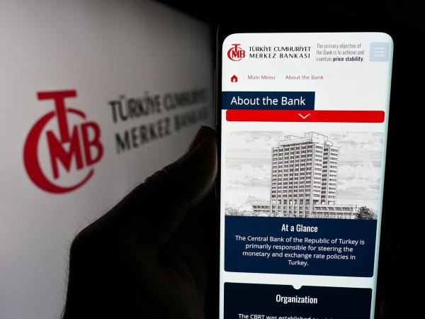 Photo illustration shows a person holding a smartphone displaying the Central Bank of the Republic of Türkiye’s official website in Stuttgart, Germany, on June 24, 2024. (Adobe Stock Photo)