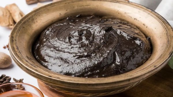 Amla recipe-a bowl filled with thick, dark amla paste used for natural hair and skincare treatment.