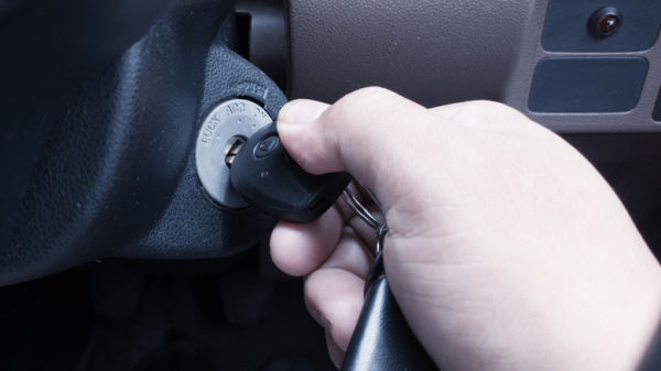 Driver holding the key in the ignition
