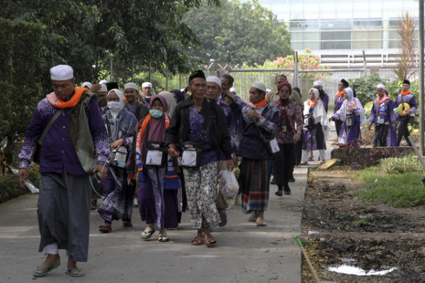 Jamaah haji pesawat Saudia Airlines SV-5688 berjalan menuju bus untuk dipindahkan ke hotel di Bandara Internasional Kualanamu, Kabupeten Deli Serdang, Sumatera Utara, Sabtu  (21/6/2025). Foto: Yudi Manar/ ANTARA FOTO