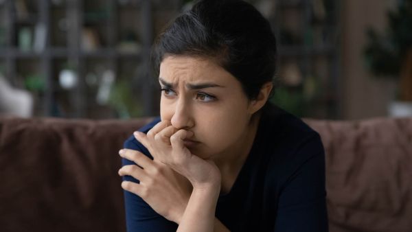 very worried woman on her couch