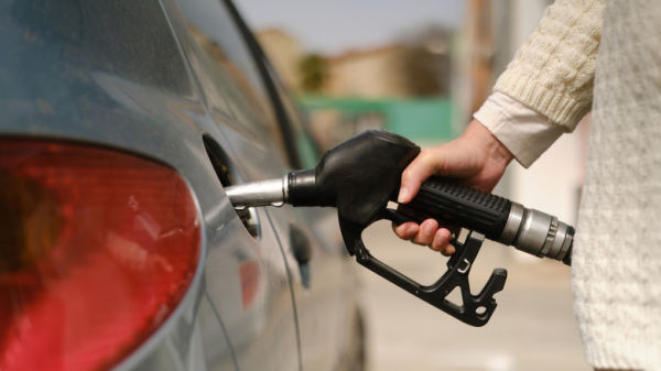 person fueling car