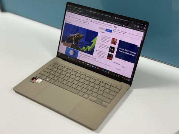 Asus Zenbook A14 sits on a table with a browser window open Asus Zenbook A14 sits on a table with a browser window open