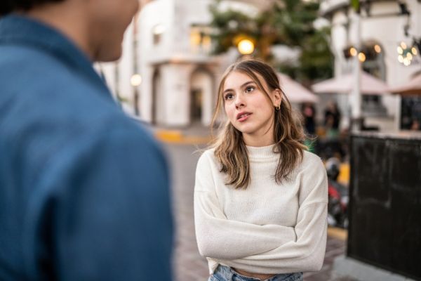 Young couple arguing outdoors.