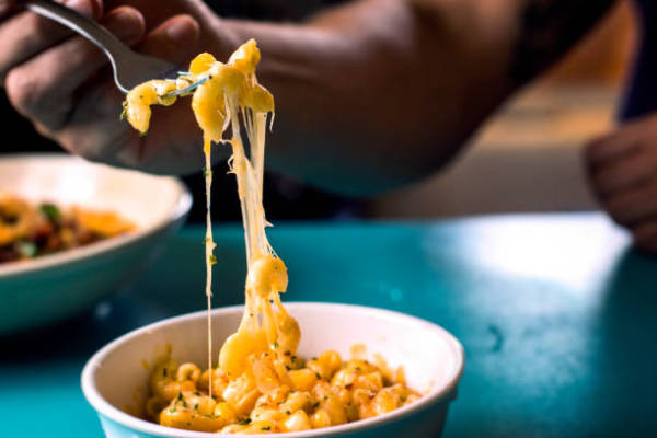 Eating a Bowel of Macaroni and Cheese Eating a Bite of Cheesy Macaroni and Cheese Mac N Cheese Stock Pictures, Royalty-FREE Photos & Images