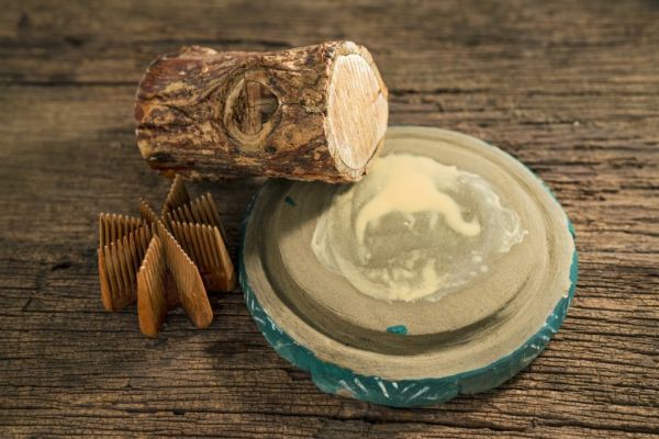 Thanaka skincare tradition: wood block, grinding stone, and comb.