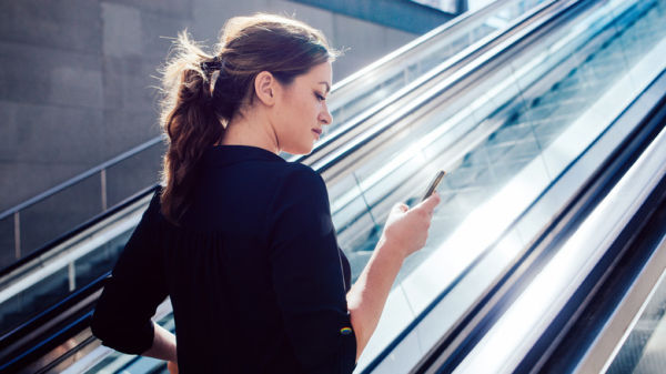 woman about to ride escalator
