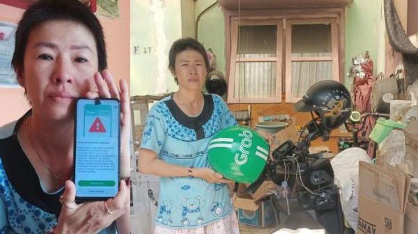 PEMULUNG - Driver ojol Rosdewi (40) sedang berdiri di samping sepeda motor miliknya dan kardus hasilnya memulung di Kota Jambi, Selasa (22/7/2025). Driver ojol itu terpaksa jadi pemulung usai akunnya disuspend setelah cekcok dengan pelanggan.