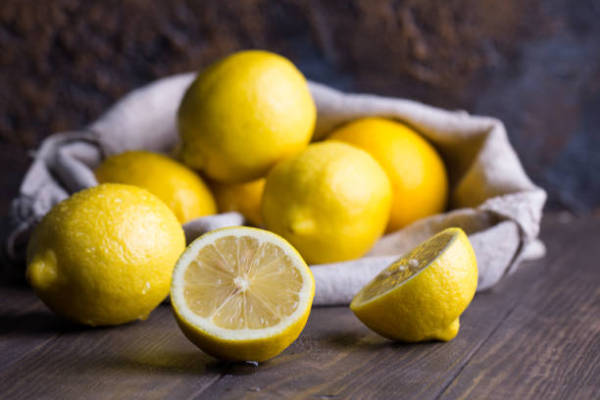 Group of Fresh Lemon on an Old Vintage Wooden Table of Fresh Ripe Lemon in Saccloth on an Old Vintage Wooden table Lemon Stock Pictures, Royalty-FREE Photos & Images