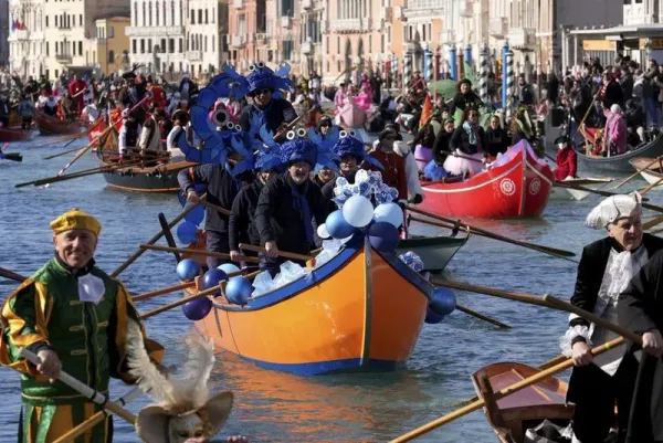Boats sail during the traditional rowing parade, part of the historical Venice Carnival, in Venice, Italy, Sunday, Feb. 16, 2025. (AP Photo/Antonio Calanni)