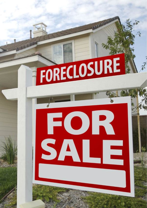 foreclosure sign in front of house