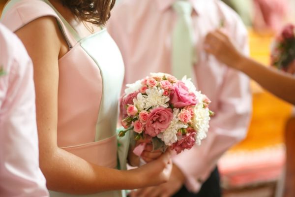 Bridesmaid holding a bouquet of pink and white flowers.