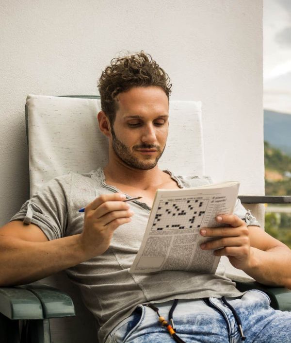 highly intelligent man doing crossword puzzle