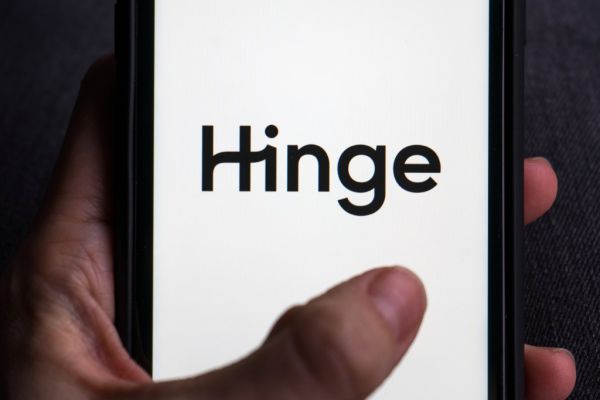 Smartphone displaying the Hinge dating app logo.