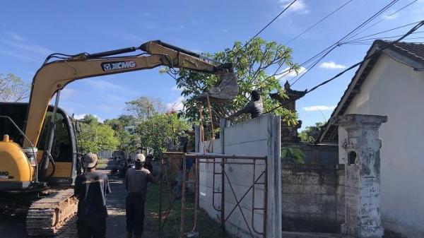 PEMBONGKARAN - Satu unit ekskavator diturunkan untuk membongkar seluruh pagar tembok beton GWK.
