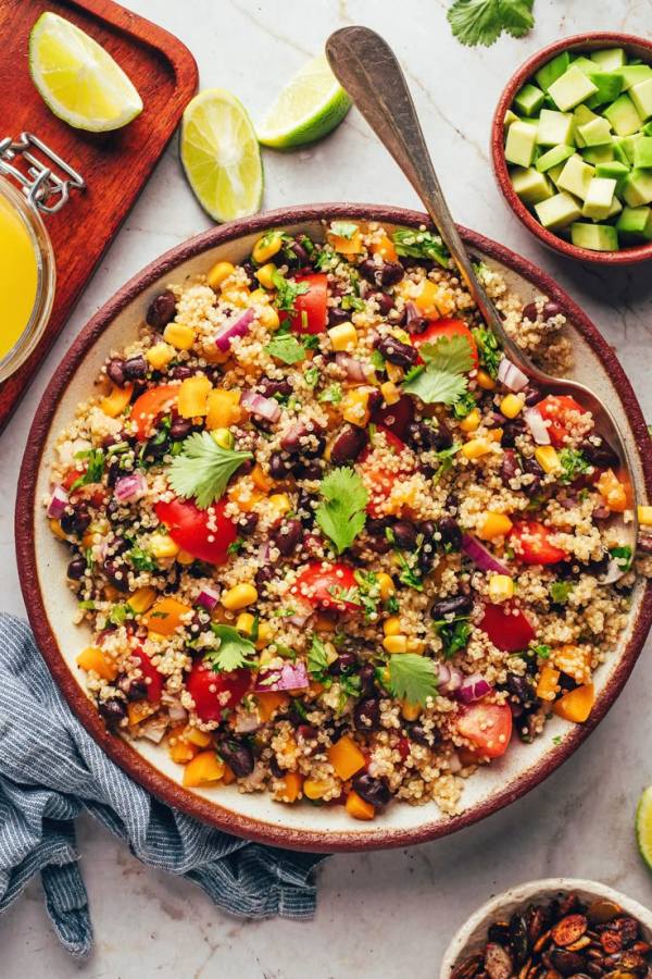 This may contain: a bowl filled with rice, beans and vegetables