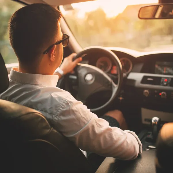 man driving car family member independence
