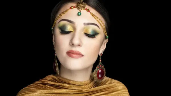 A stunning woman in a beautiful makeup showcasing her long hair and hair accesories