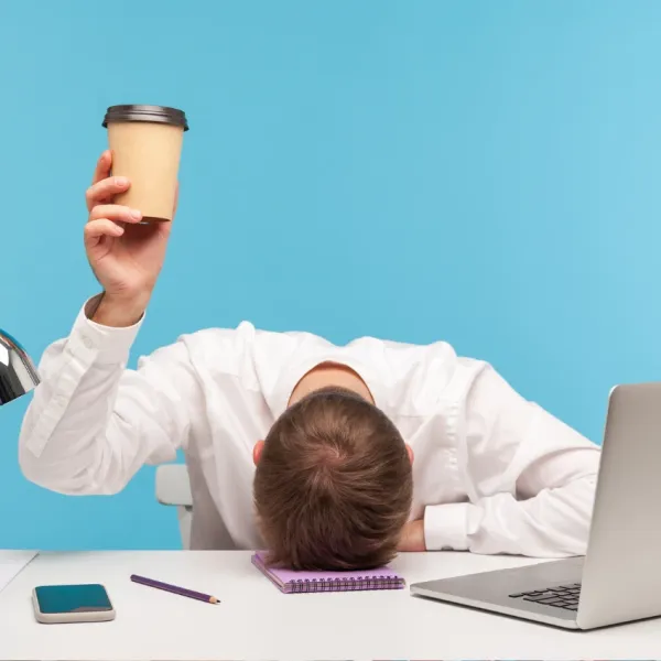 tired office worker drinking coffee in the afternoon