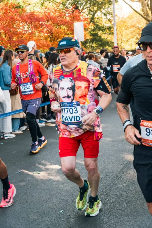 A runner wearing a custom-made t-shirt covered in faces.