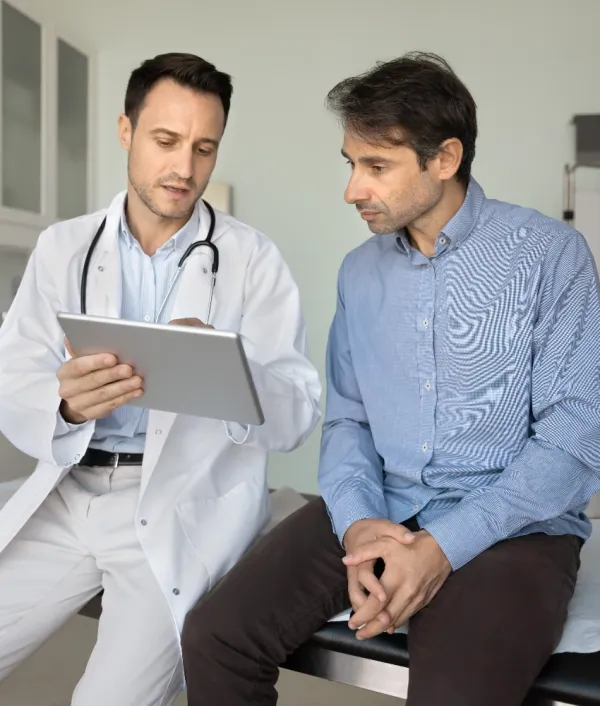 man using health insurance plan at doctor's appointment