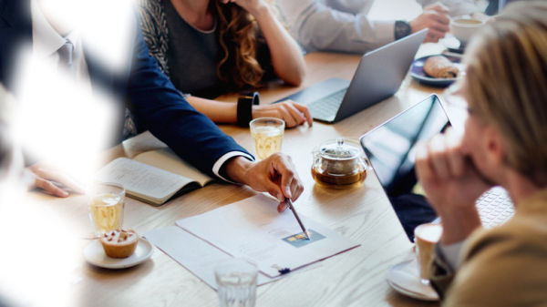 Office people working around a table.
