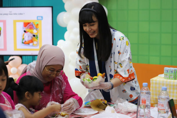 Bento instructor, Rina Mutia Dewi saat menujukkan kreasi bento kepada orang tua yang mendampingi anaknya saat mengikuti kumparanMOM Playdate bersama MilkLife yang digelar di kantor kumparan, Jakarta, Sabtu (22/11/2025). Foto: Iqbal Firdaus/kumparan