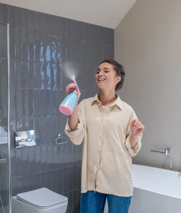 Woman spraying air freshener but partner is aware of her bathroom habits
