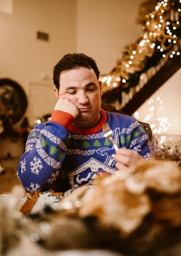 gen z man eating Christmas dinner with his family