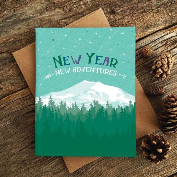 This may contain: a greeting card with the words new year, and pine cones on top of it